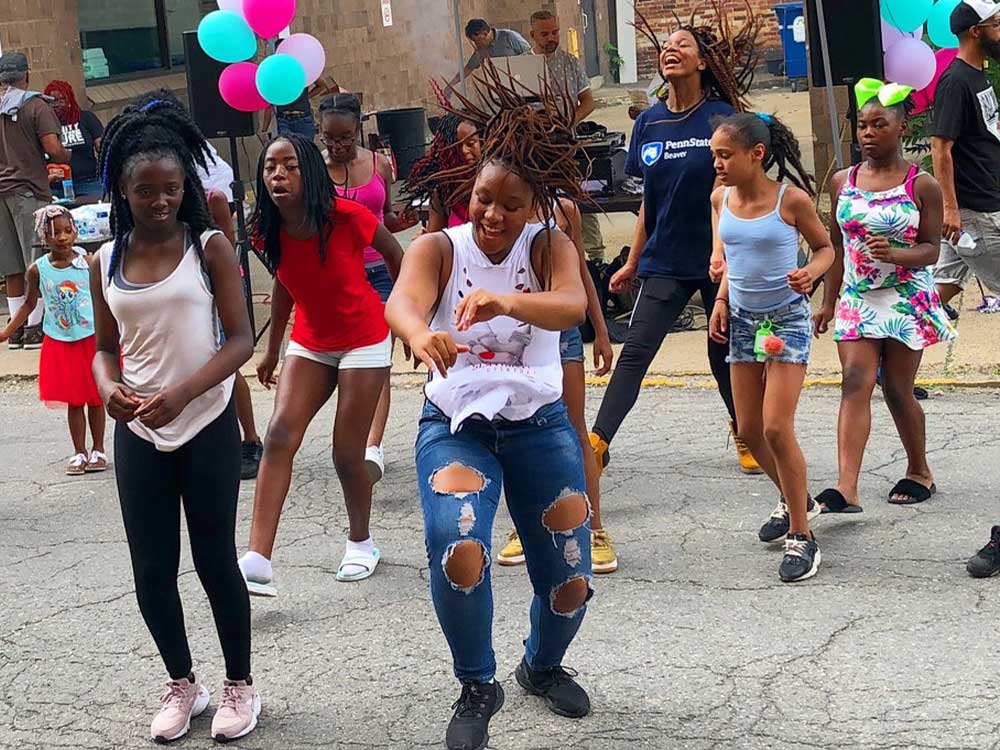girls dancing on the street during an event