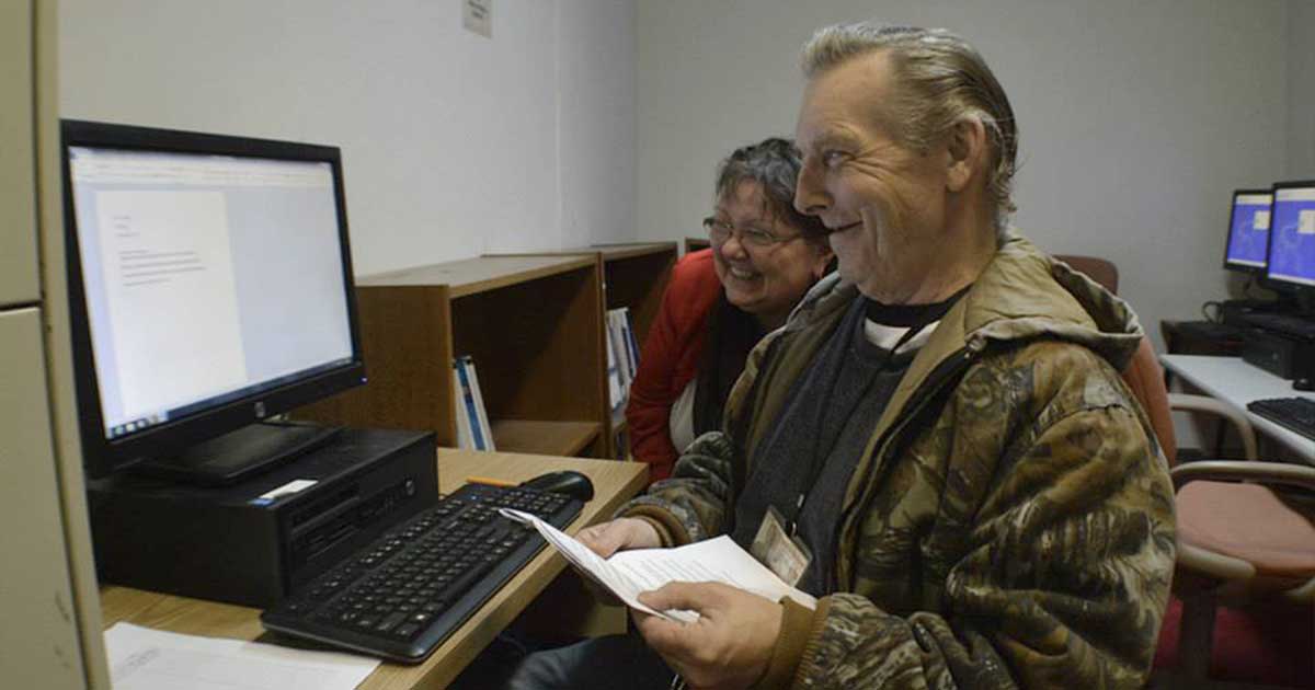 smiling man using computer